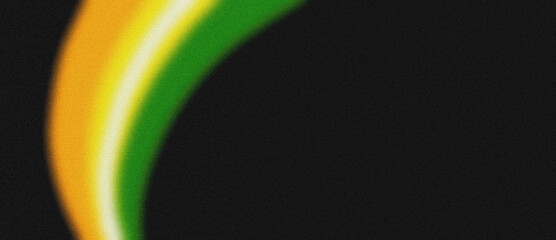 Vibrant, swirling curves of green, yellow, and orange gracefully emerge from a velvety black background, creating an energetic burst of color.