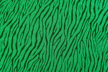 
Texture of colored paper. Decorative sheet of cardboard with a zebra pattern. Green shiny background