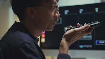 Modern man freelancer using AI voice assistant to make hands-free searches while working remotely, boosting productivity, embracing smart technology in a flexible work environment