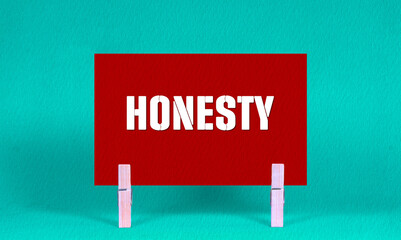 HONESTY Symbol. Concept words HONESTY on Red Rectangle Paper Held by Wooden Clothespin Green...