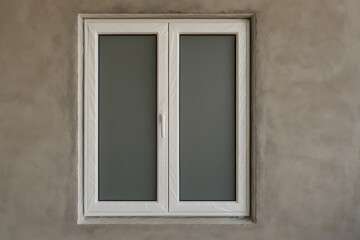 Double-pane window unit framed in rough wall opening awaiting installation in window replacement project