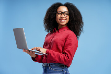 Smiling Professional Using Laptop on Blue Background