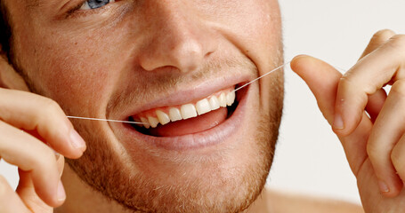 Oral health, floss and man in studio with hygiene, wellness and mouth routine in morning. Dental...