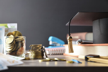 High cost of education concept with money and educational supplies