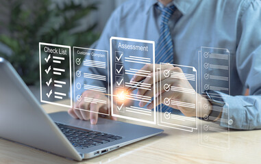 Businessman taking online survey on laptop, selecting answers in digital exam form to evaluate performance, quality, and feedback for assessment and analysis