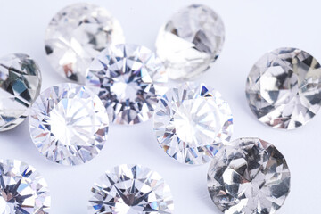 Many beautiful shiny diamonds on white background, closeup