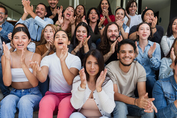 Diverse group of latin people applauding after successful conference in convention center in Mexico...
