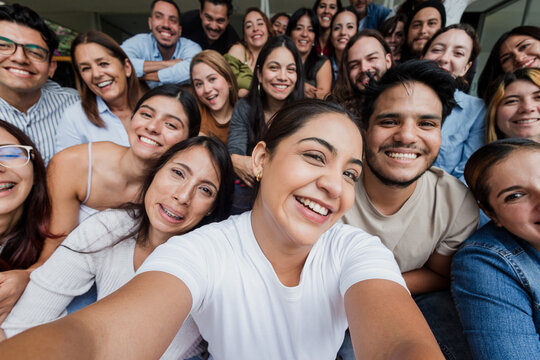 Hispanic friends taking big group selfie shot smiling at camera outdoors in Mexico Latin America, Laughing latin young people and Human resources concept