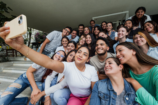 Hispanic friends taking big group selfie shot smiling at camera outdoors in Mexico Latin America, Laughing latin young people and Human resources concept