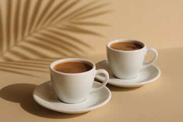 Two cups of coffee sitting on top of a table