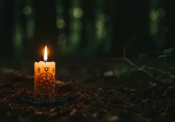 Poster Candle glowing in a dark forest at night . Mystical and nature magical ritual concept for spiritual offerings. Wiccan and Pagan holidays magic practices background for banner with copy space.  