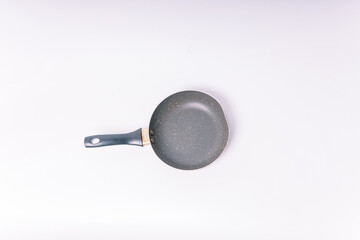 Top view Black frying pan with a non-stick coating isolated on white background.
Frying pan for cooking meat and vegetables on a white background.
