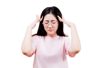 Asian young beautiful woman in a pink shirt wearing glasses holds her head with a pained...