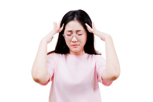 Asian young beautiful woman in a pink shirt wearing glasses holds her head with a pained expression, appearing stressed or experiencing a headache.
