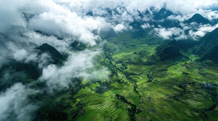 Obraz premium Overlooking the mist-shrouded terraced mountains from the air, it features green rice paddies, mountain peaks, and terraced lines, creating a tranquil atmosphere.