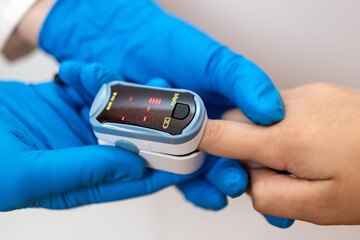 The child's saturation is measured using a pulse oximeter.