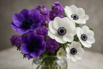 A vase filled with purple and white flowers on a table