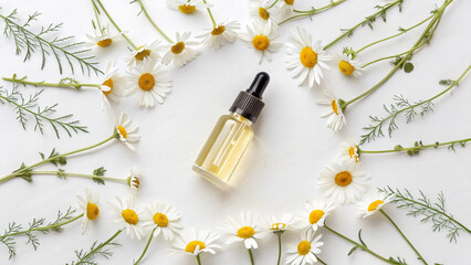 Clear dropper bottle with yellow liquid, elegantly surrounded by fresh, delicate chamomile flowers.