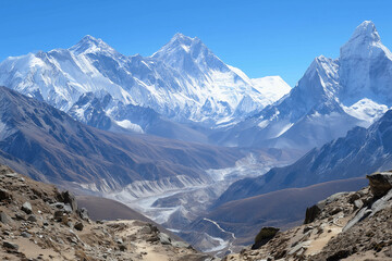 a mountain range with a river running through it and snow capped mountains in the background, with a blue sky