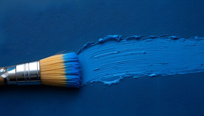 Close-Up Photo of Paintbrush and Blue Paint Stroke on Dark Textured Surface