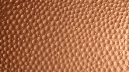 Texture surface of hammered copper metal with warm tones and reflective highlights perfect for background design craft projects industrial decor and vintage style warm cozy ambiance