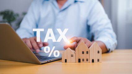 Person with holographic TAX % and house models for property tax and financial planning