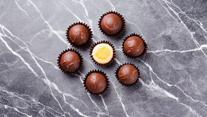 World Chocolate Day celebration. Assorted chocolate treats on a dark background. Sweetness, indulgence, and dessert temptation.