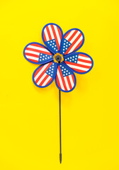 colorful american flag windmill on yellow background