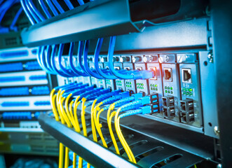 Fiber Optical cables connected to an optic ports and Network cables connected to ethernet ports