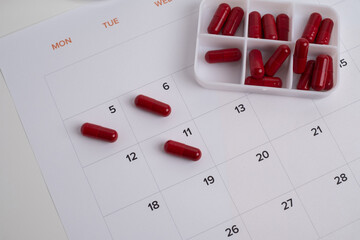 Dosage of pills by day, medication calendar, pill organizer with copy space.