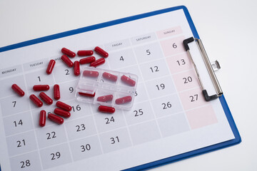 Dosage of pills by day, medication calendar, pill organizer with copy space.