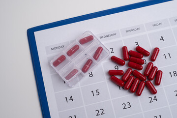 Measuring tape and tablets, vitamins on a light background with space for text. Concept of losing...