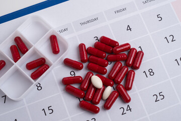 Dosage of pills by day, medication calendar, pill organizer with copy space.