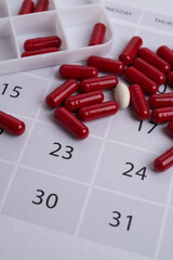 Dosage of pills by day, medication calendar, pill organizer with copy space.