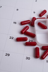 Dosage of pills by day, medication calendar, pill organizer with copy space.