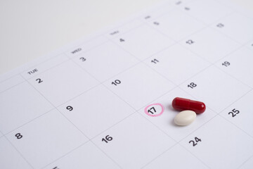 Dosage of pills by day, medication calendar, pill organizer with copy space.