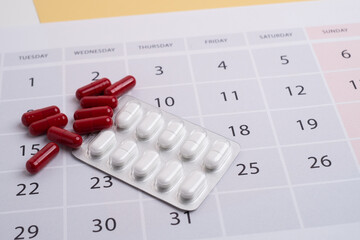 Dosage of pills by day, medication calendar, pill organizer with copy space.