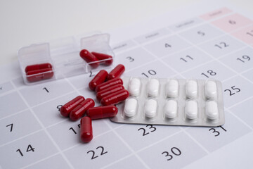 Dosage of pills by day, medication calendar, pill organizer with copy space.