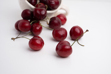 Fresh cherries in a ceramic cup on the table. A handful of delicious berries. Antioxidants and vitamins