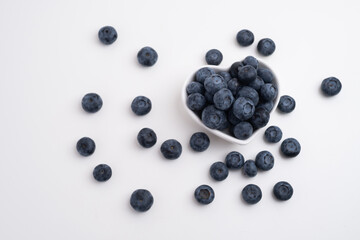 Fresh organic blueberries in a plate on a light background. Antioxidants and vitamins