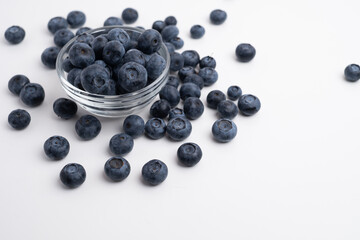 Fresh organic blueberries in a plate on a light background. Antioxidants and vitamins