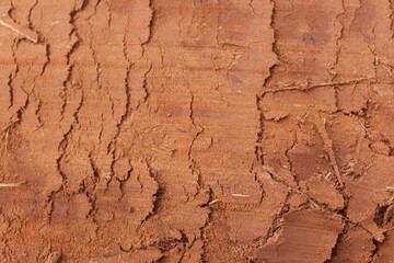 Implement and Tire Traces on Soil. Dry layered soil close-up with clay texture
