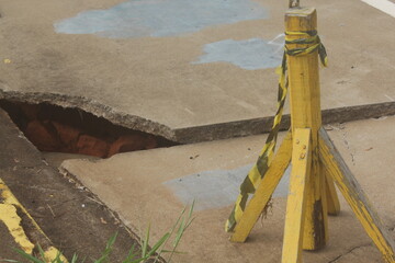 Rain-damaged asphalt collapsed