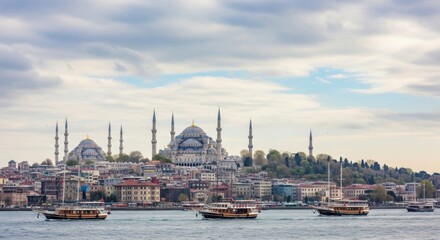 Fototapeta premium Majestic Cityscape with Historic Mosques and Boats on the Water Under a Cloudy Sky