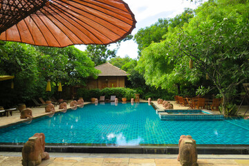 View of a hotel swimming pool and umbrella in Bagan, Myanmar