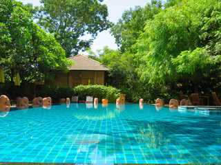 Hotel Swimming Pool Surrounded by Tropical Trees in Bagan, Myanmar
