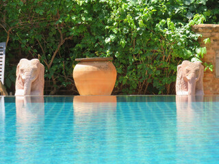 Statues next to a hotel swimming pool in Southeast Asia