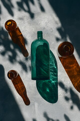 Artistic Still Life with Colored Glass Bottles and Shadow Play in Natural Light
