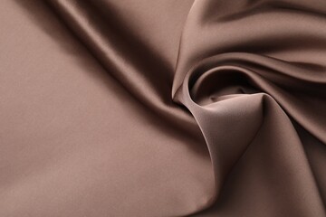 Crumpled light brown silk fabric as background, top view