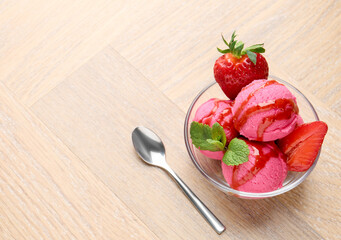 Refreshing sorbet with syrup, strawberries and mint in bowl on wooden table, above view. Space for text